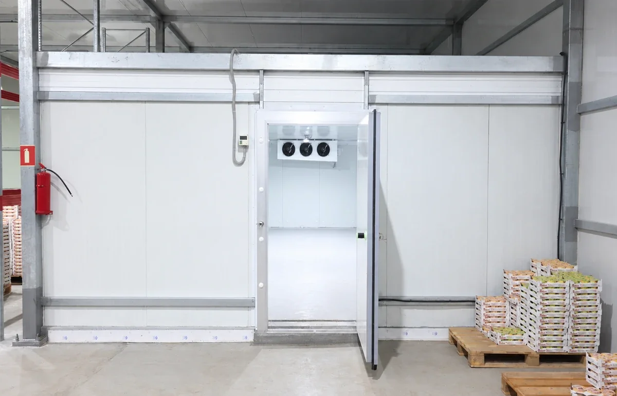 Insulated cold room door open on a fruit storage room built by Vikkins