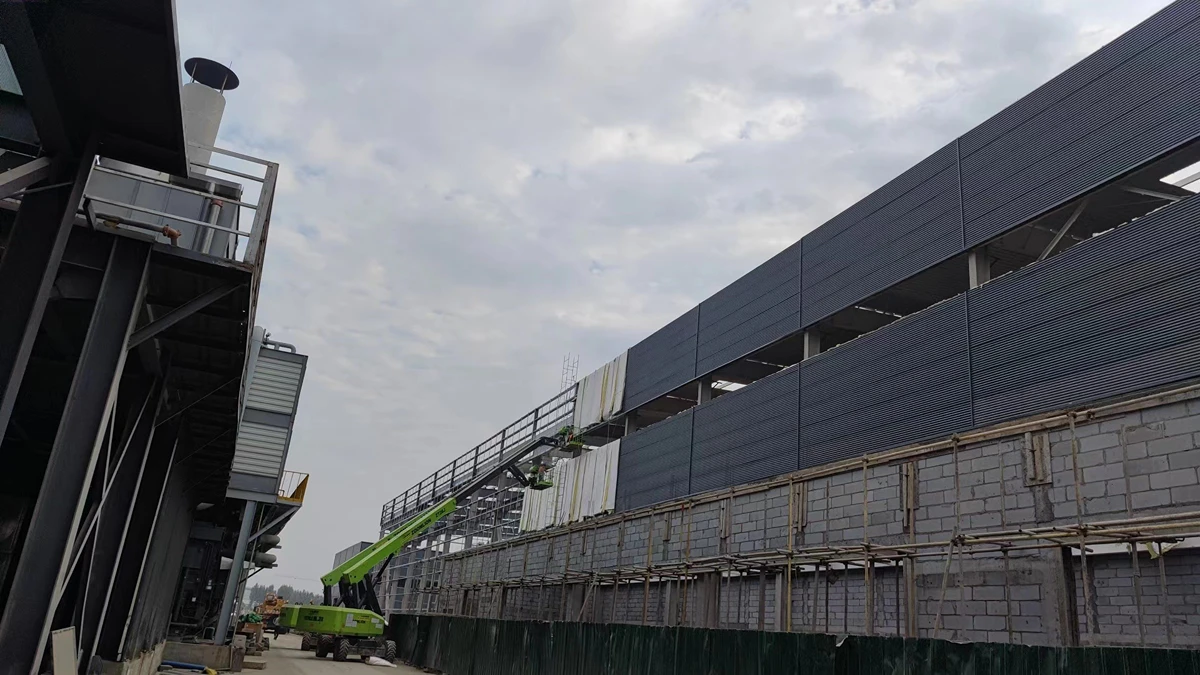 Local team installing wall cladding on a Vikkins steel building from a boom lift