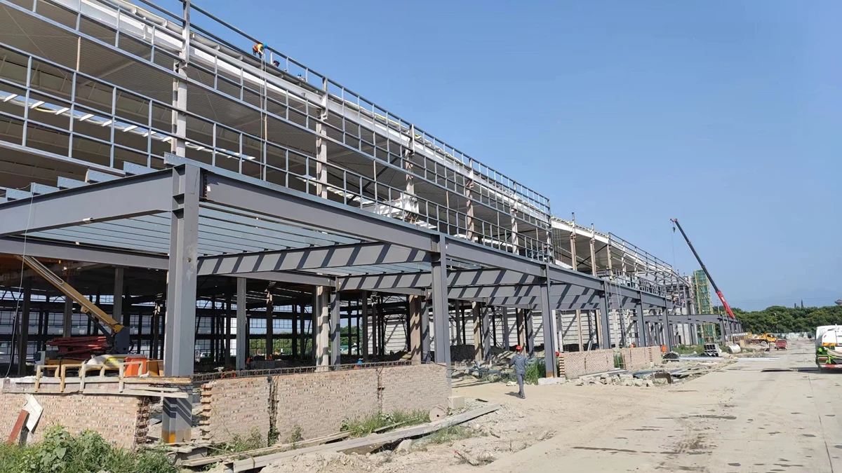 Steel building installation: a local crew erecting a bolt-together Vikkins steel structure frame